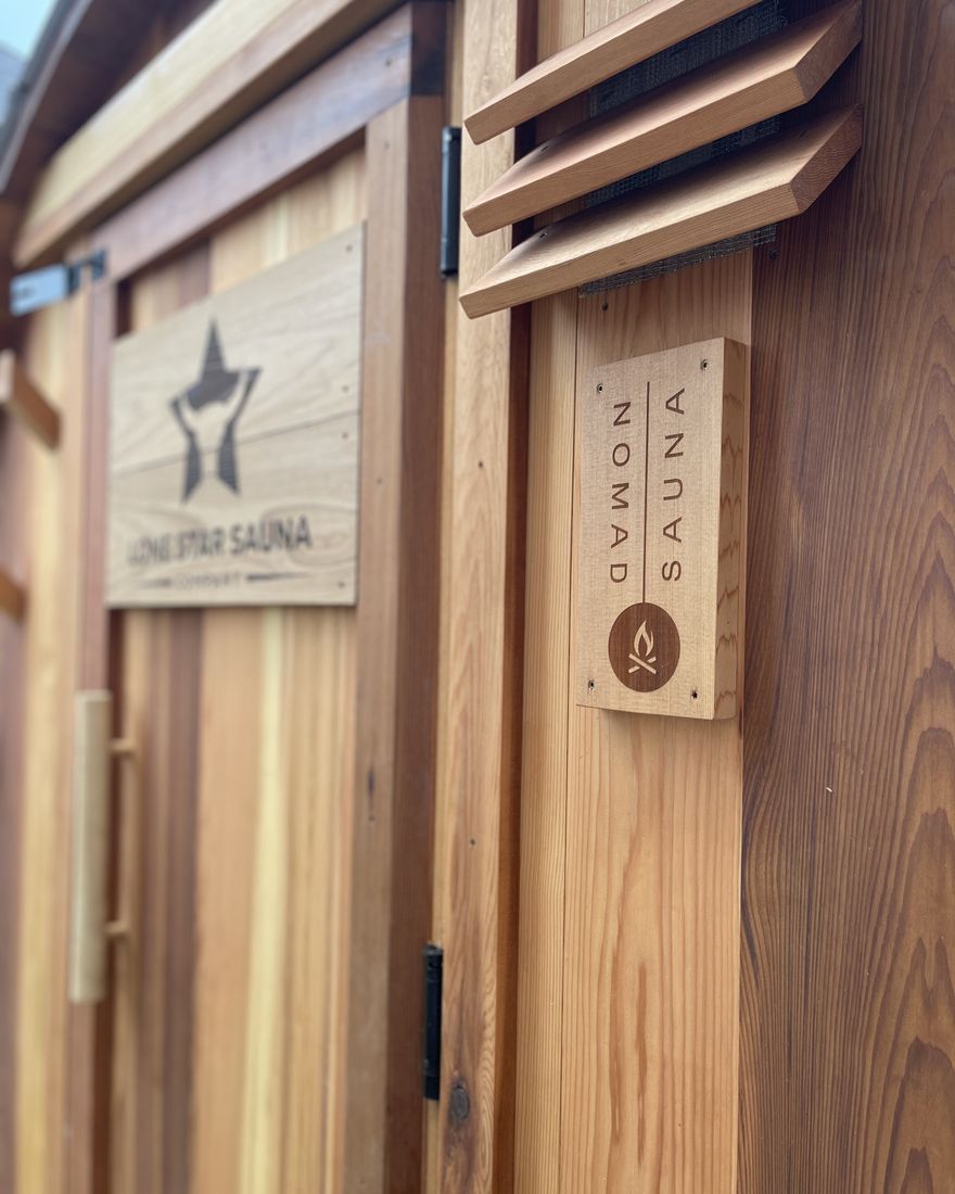 Cedar exterior detail with the Lone Star Sauna and Nomad Sauna plaques