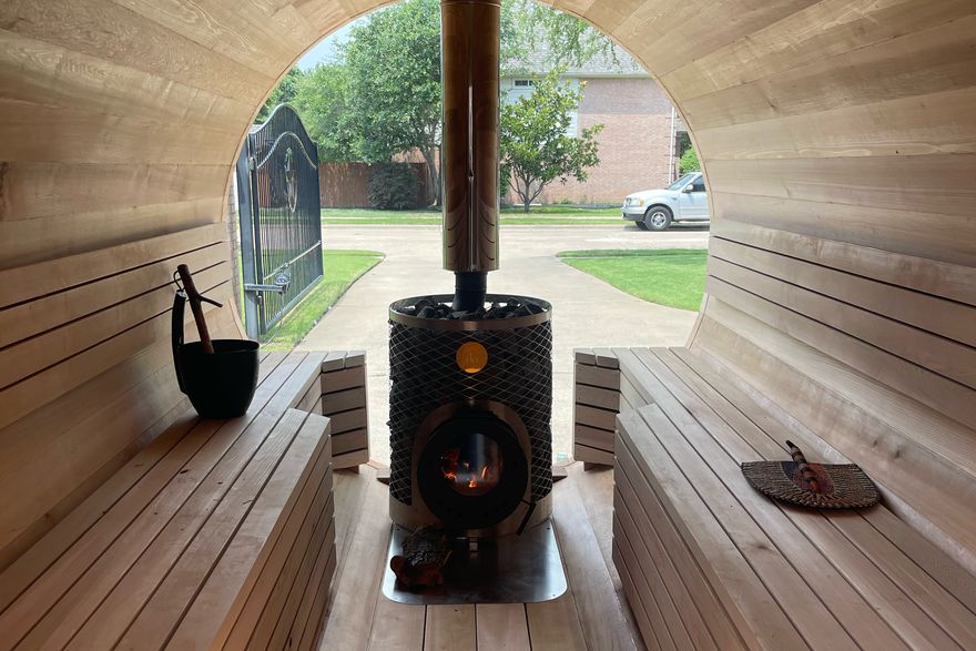 Inside the sauna looking out toward the open door and the Iki stove