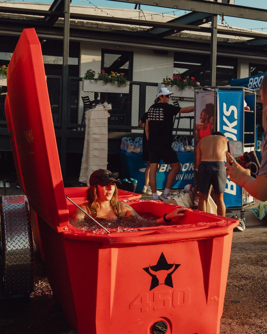 A guest in the cold plunge at an event activation