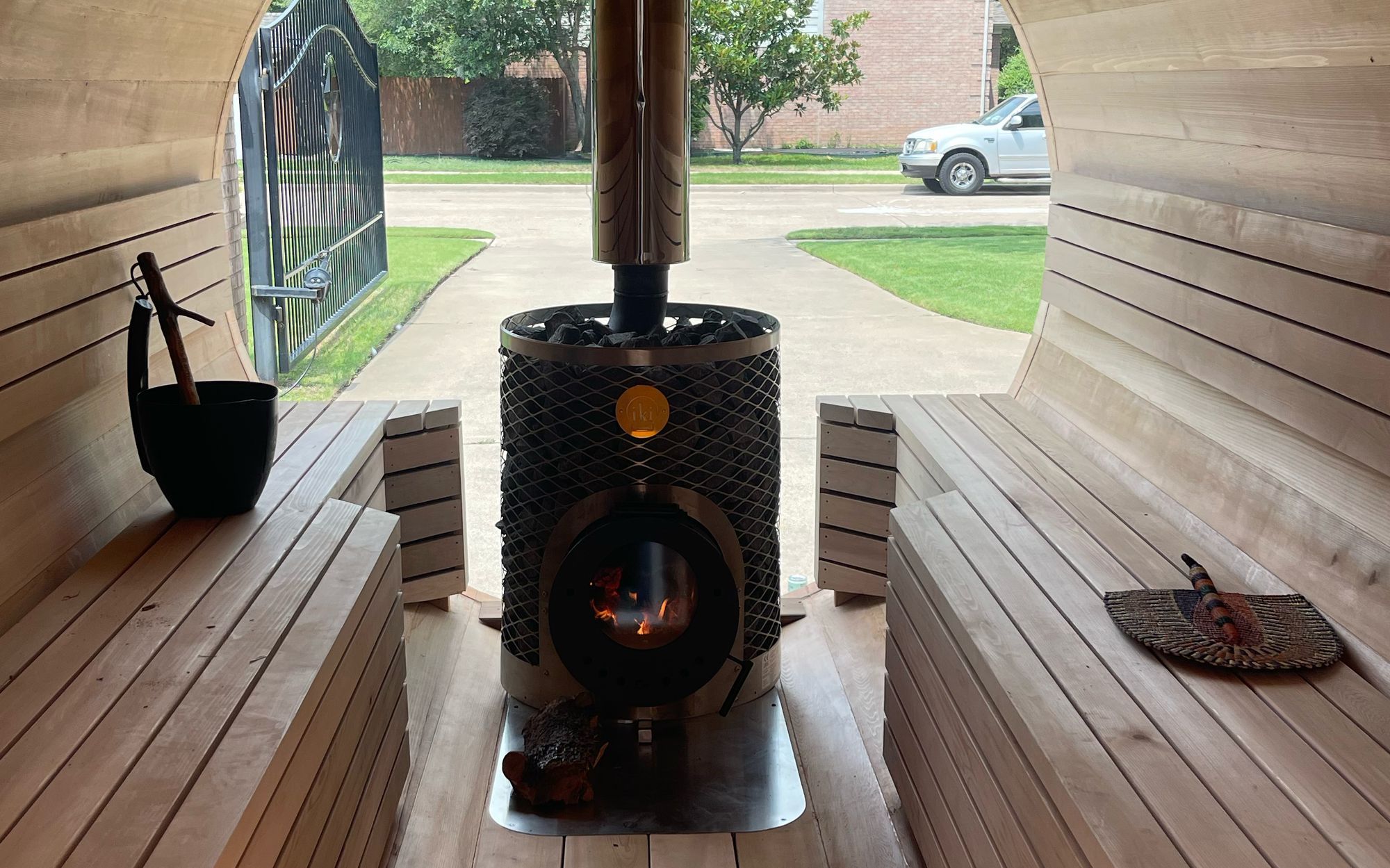 Inside the Lone Star Sauna barrel, cedar benches and a wood-fired Iki stove